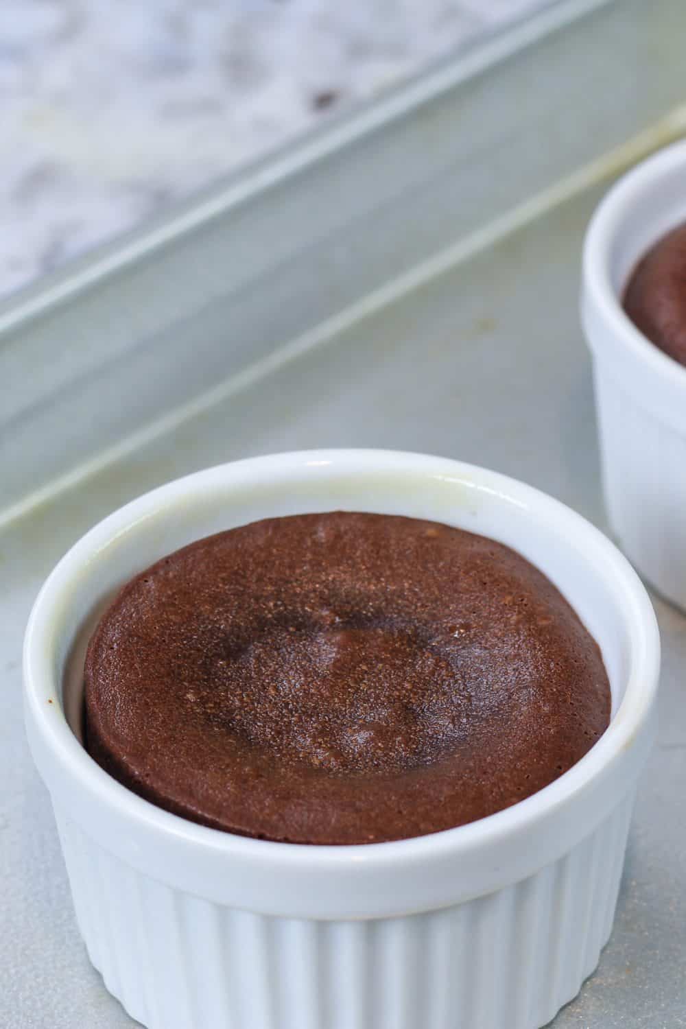 baked chocolate lava cake in a white ramekin