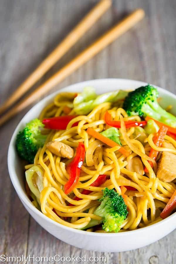 A bowl of Chicken Chow Mein with chopsticks nearby. 