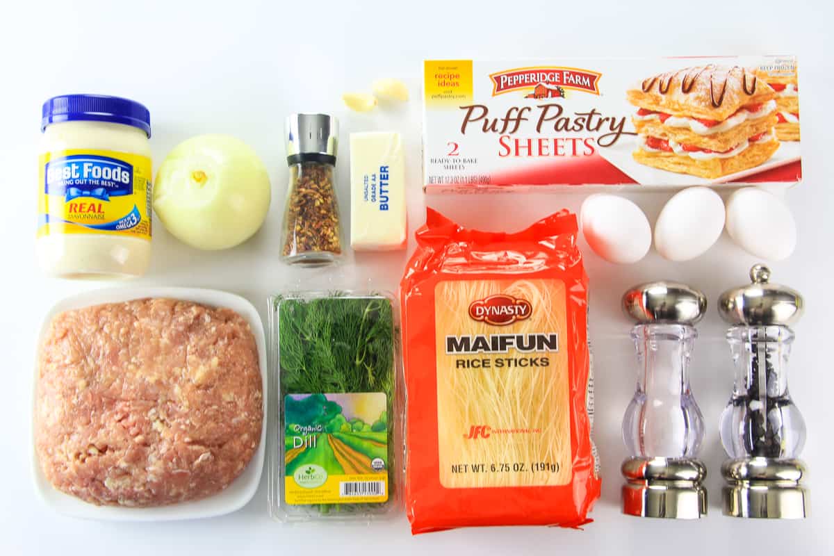 Ingredients for chicken puff pastry roll laid flat on a white surface