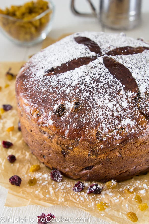 panettone bread on brown parchment paper with powdered sugar on top