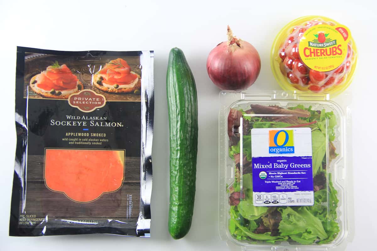 This smoked salmon salad is a bright and flavorful salad loaded with mixed baby greens, smoked lox salmon, and chopped vegetables. Its a delightful and filling salad perfect for summer time. #smokedsalmon #smokedsalmonsalad #salmonsalad #loxsalad ingredients for smoked salmon salad