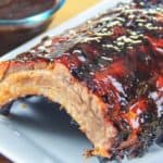 rack of barbecue ribs on a white plate