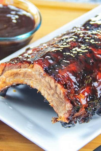 rack of barbecue ribs on a white plate