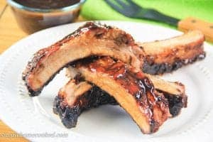 barbecue pork ribs stacked on each other on a plate