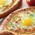 khachapuri cheese bread boat with an egg in the center
