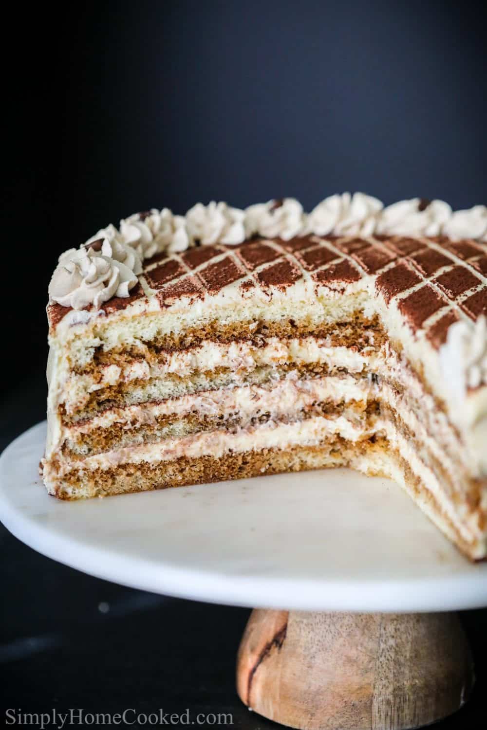 sliced tiramisu cake with cocoa powder on top