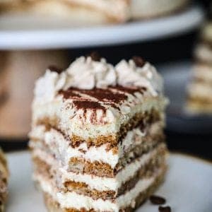 sliced tiramisu cake with cocoa powder on top