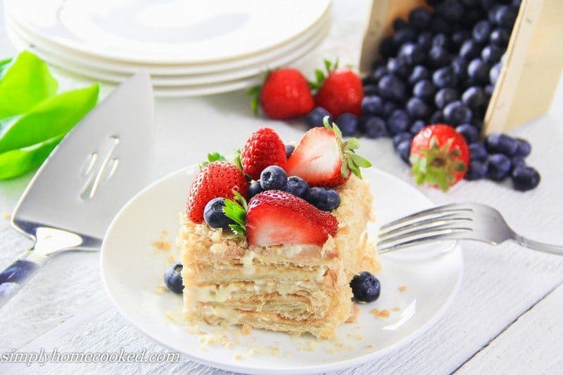 Slice of Easy Napoleon Cake with a fork and berries.