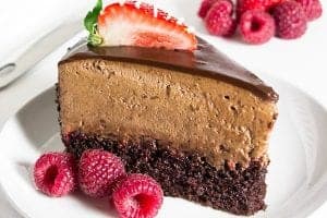Chocolate raspberry mousse cake slice with fresh raspberries and strawberries