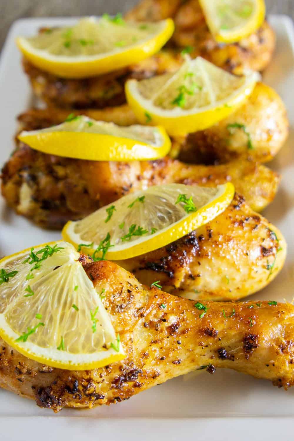 A plate full of baked lemon chicken