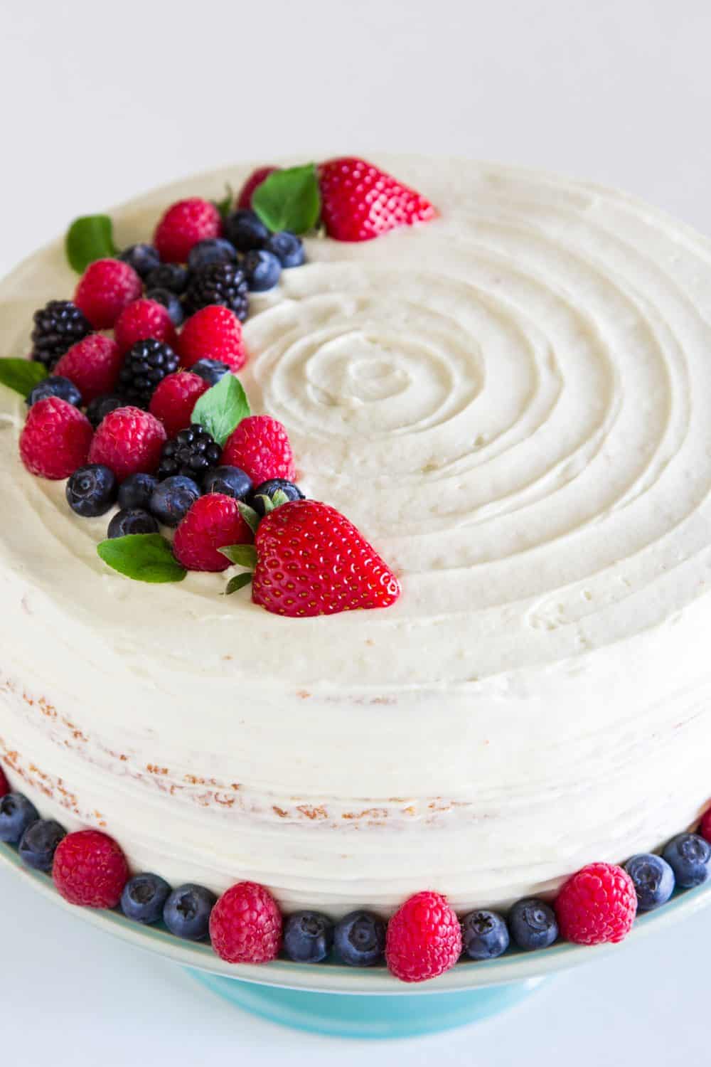 white Chantilly cake with berries on top