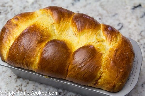 baked brioche bread in a loaf pan