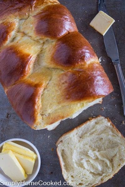 brioche bread loaf with a slice of brioche bread and sliced butter beside it