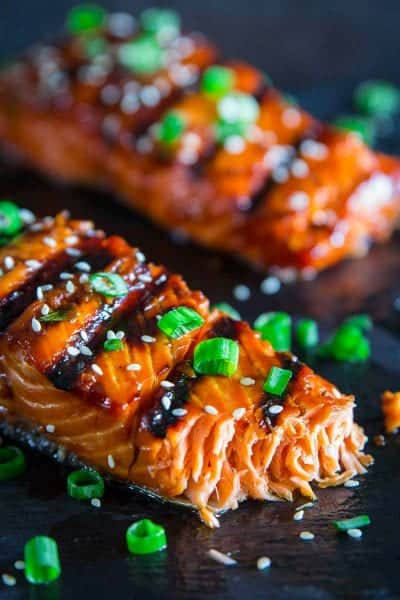 grilled teriyaki salmon with green onion and sesame seeds on top