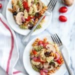 The secret to a great tri color pasta salad is to fill it with your favorite brightly colored flavorful vegetables. Add mushrooms for extra protein and flavor!