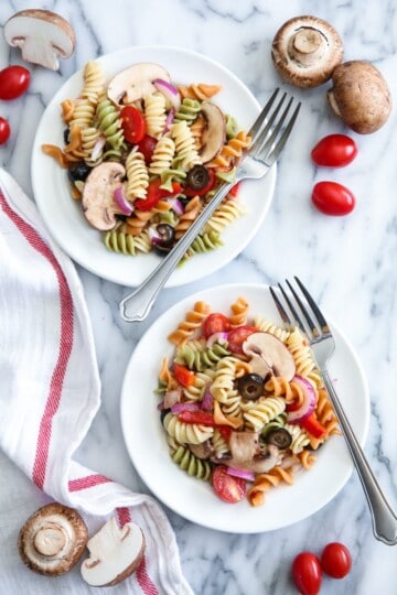The secret to a great tri color pasta salad is to fill it with your favorite brightly colored flavorful vegetables. Add mushrooms for extra protein and flavor!