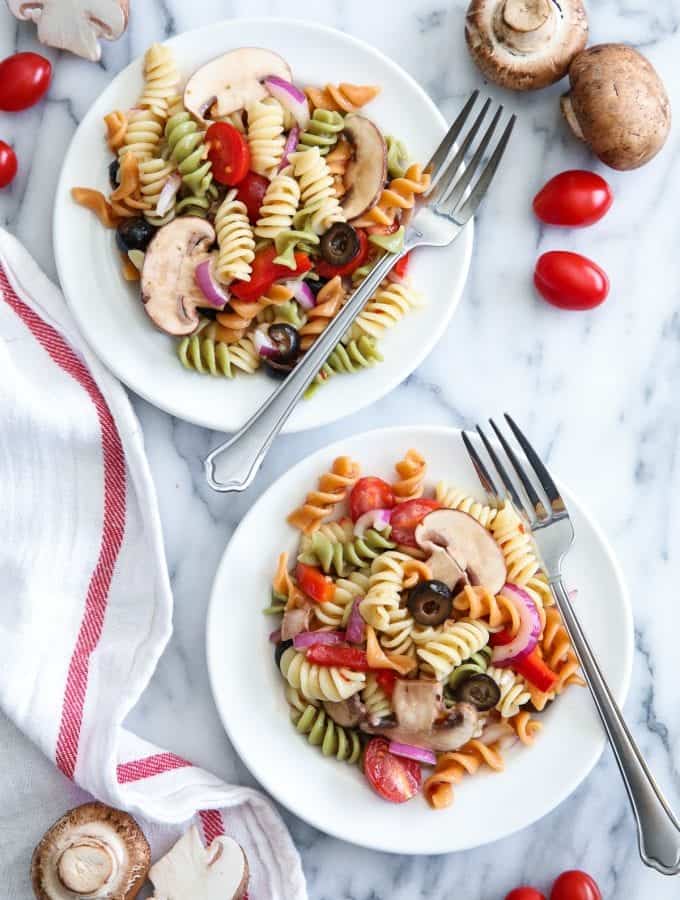 The secret to a great tri color pasta salad is to fill it with your favorite brightly colored flavorful vegetables. Add mushrooms for extra protein and flavor!