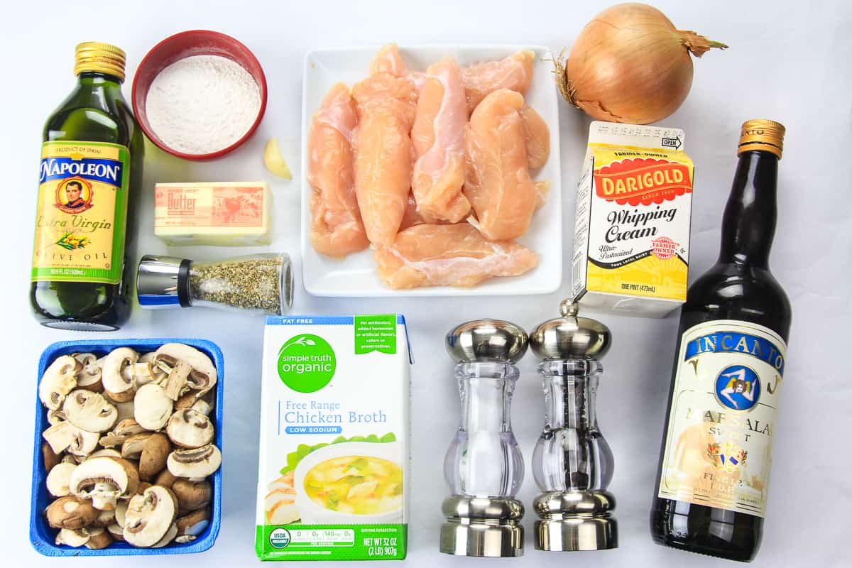 overhead image of ingredients for homemade chicken marsala on a white background