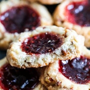 raspberry filled cookies stacked on top of each other