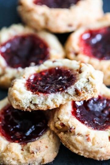 raspberry filled cookies stacked on top of each other