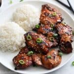 Close up of plate of Grilled Teriyaki Chicken with rice and sauce nearby