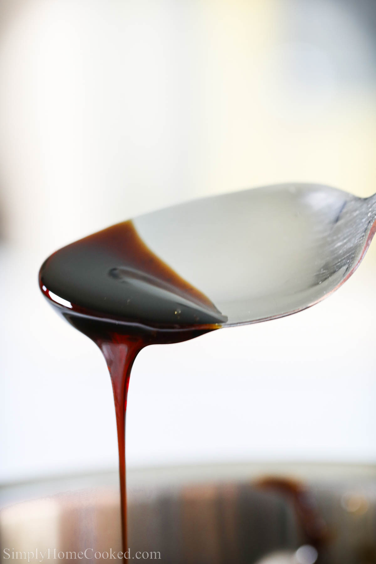 Balsamic Glaze dripping off a spoon. 