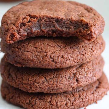 close up image of a bitten Nutella cookies stacked on top of Nutella cookies