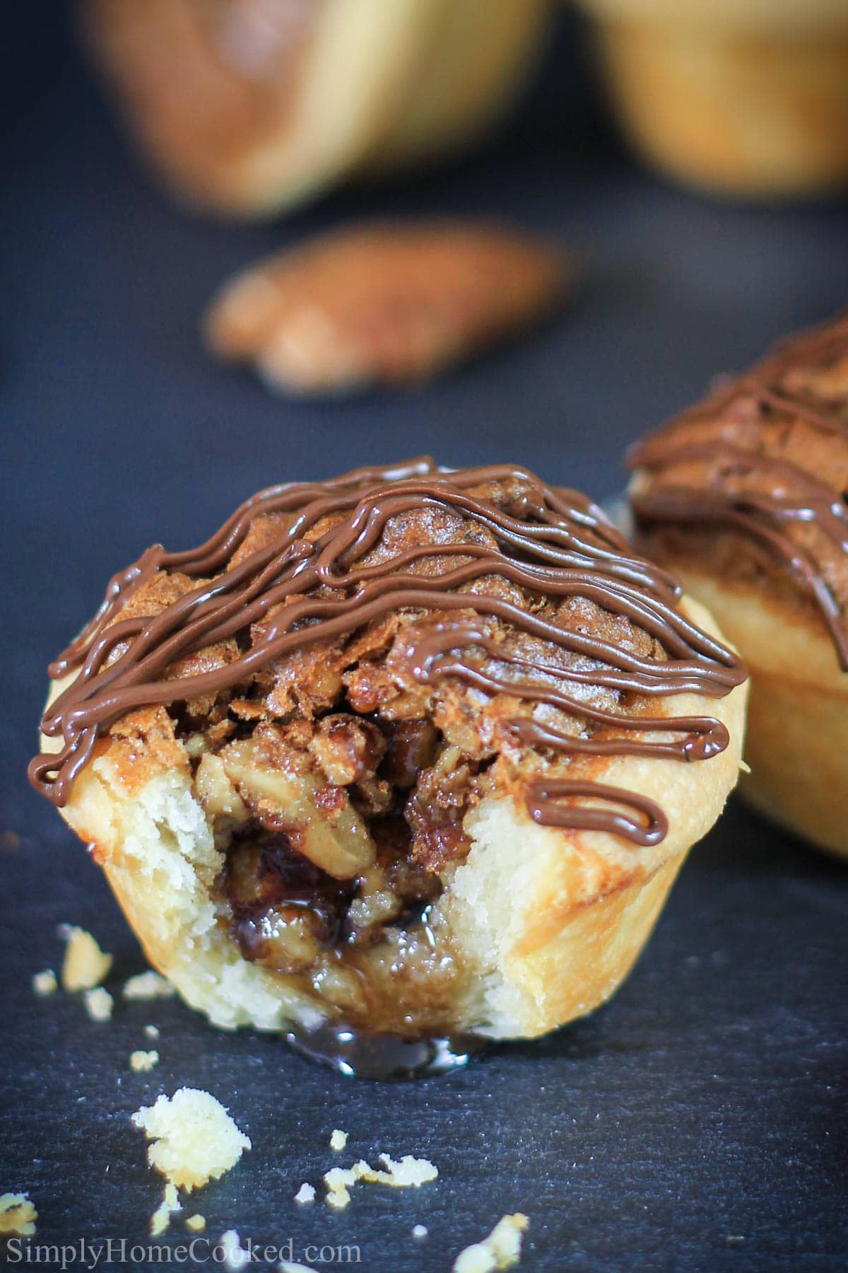 close up image of Pecan Tassies, one missing a bite.