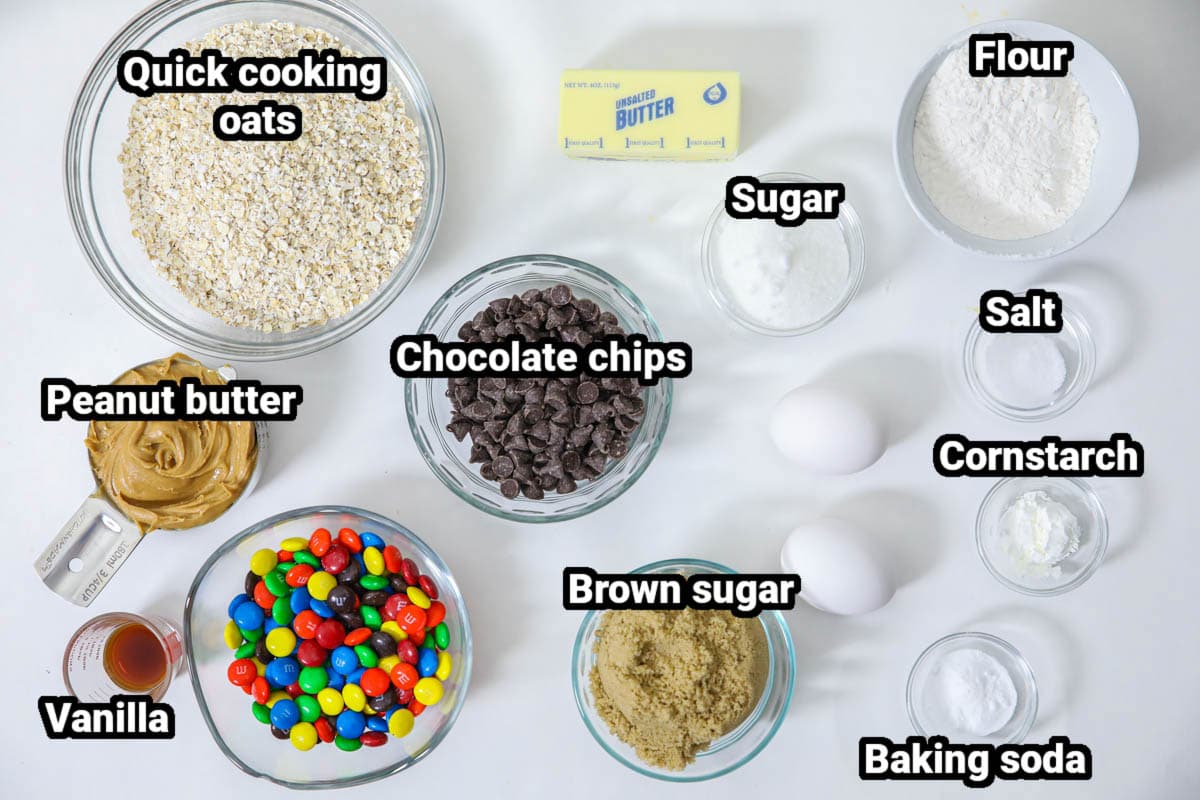 Ingredients for Monster Cookies: oats, flour, peanut butter, vanilla, M&amp;Ms, brown sugar, butter, chocolate chips, eggs, sugar, salt, cornstarch, and baking soda.