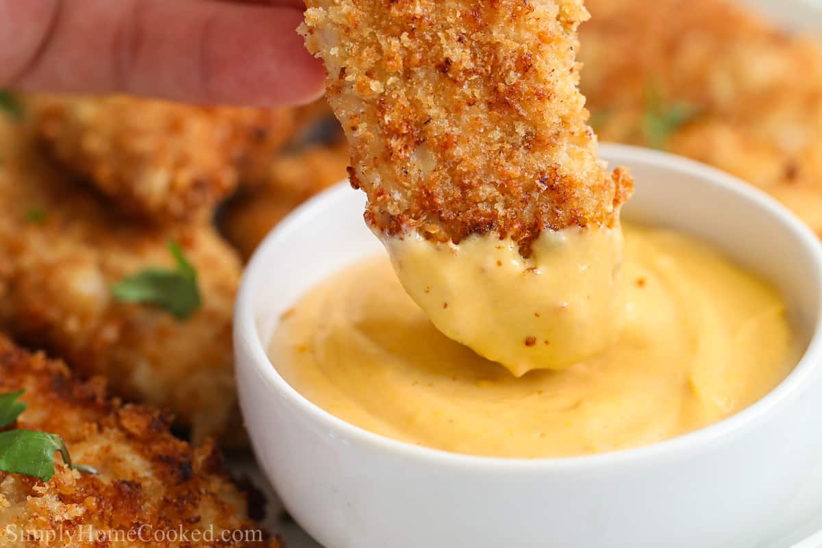 Close up of chicken finger dipped in 3-ingredient Chick-fil-a sauce