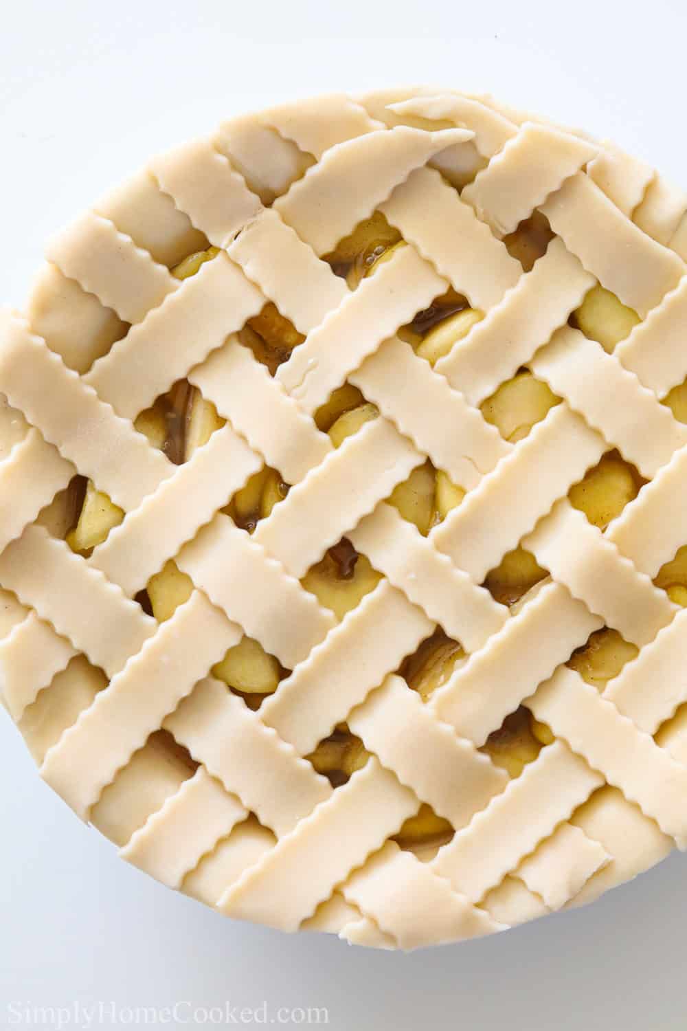 Latticed Homemade Apple Pie with a white background.