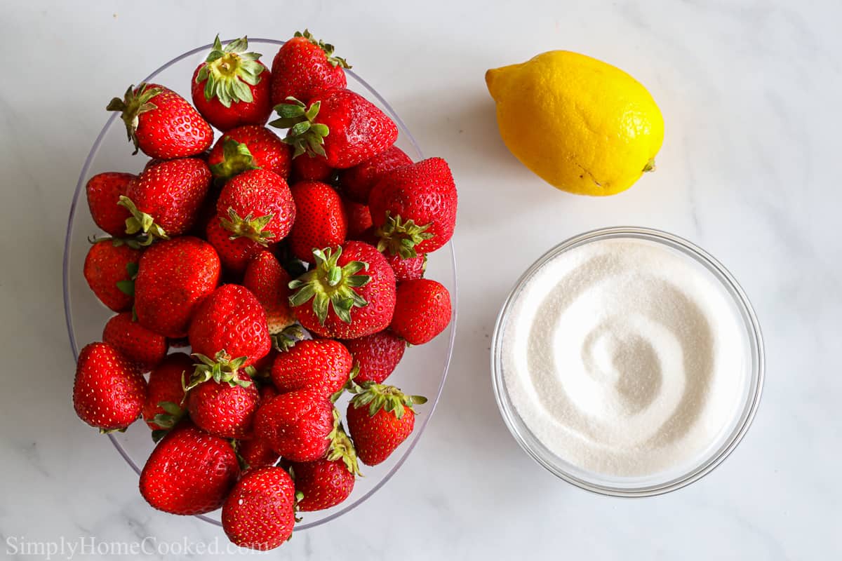 an overhead image of ingredients for strawberry jam on a white background