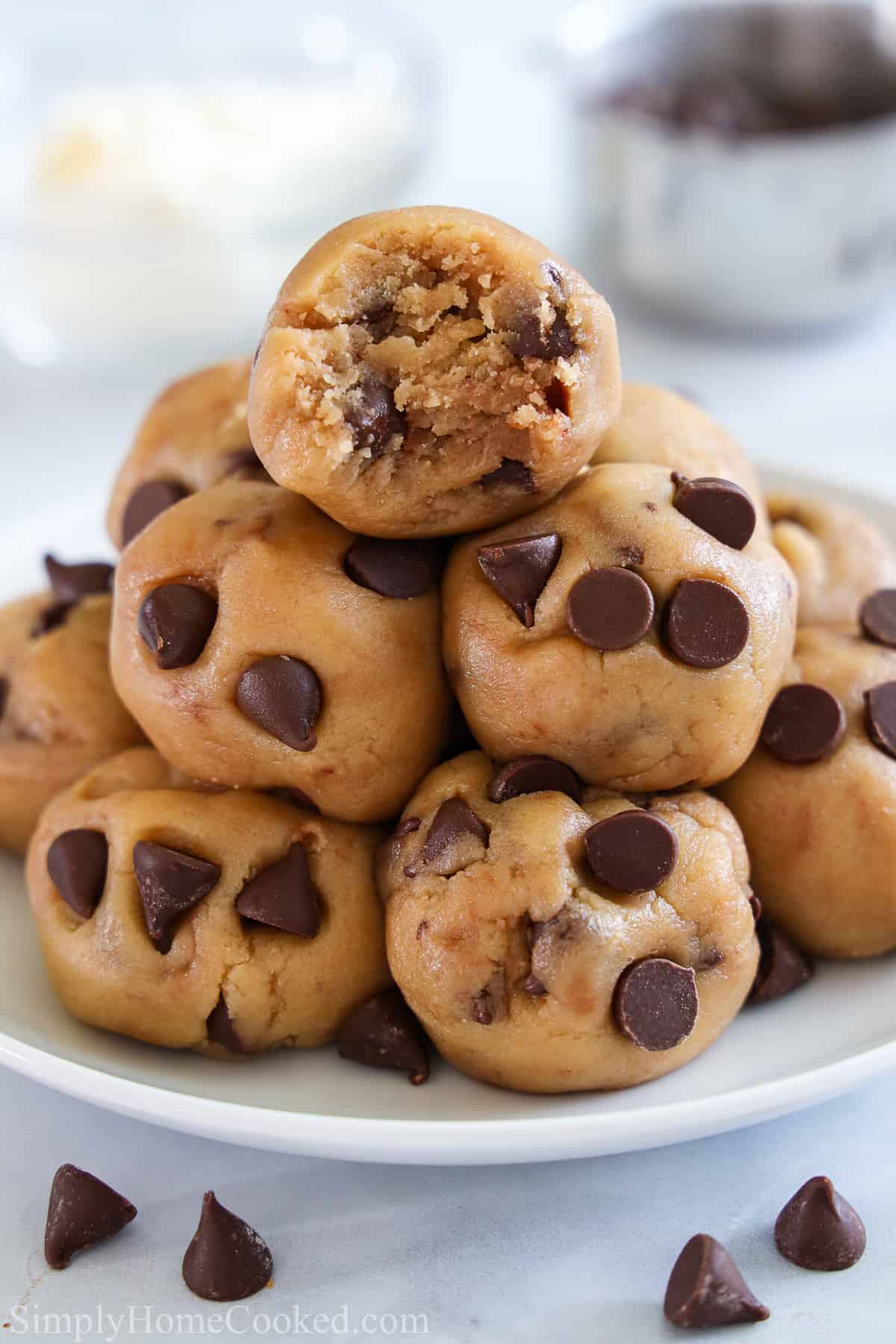 Closeup of a pile of balls of Edible Cookie Dough, the top one missing a bite.