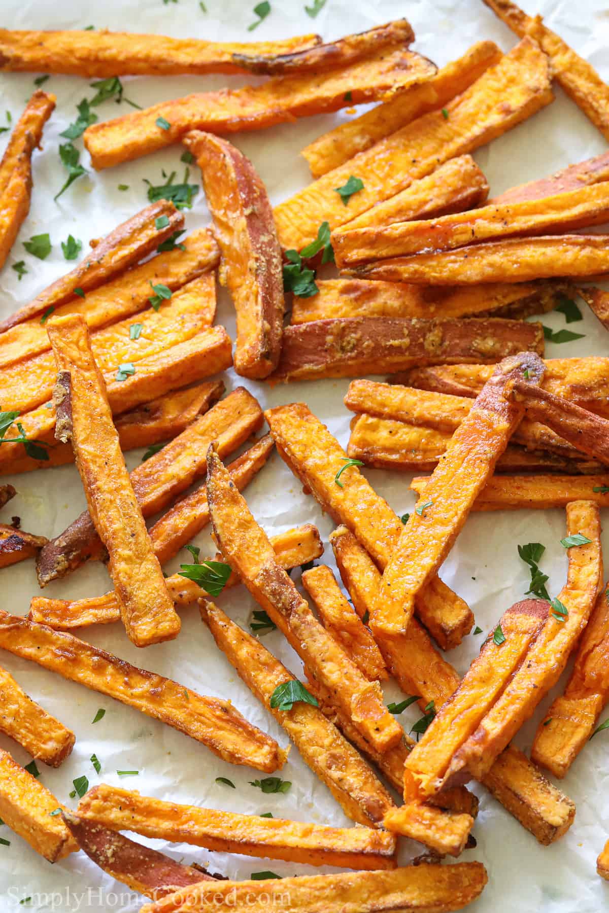 Close up of the Best Air Fryer Sweet Potato Fries with a sprinkling of parsley.