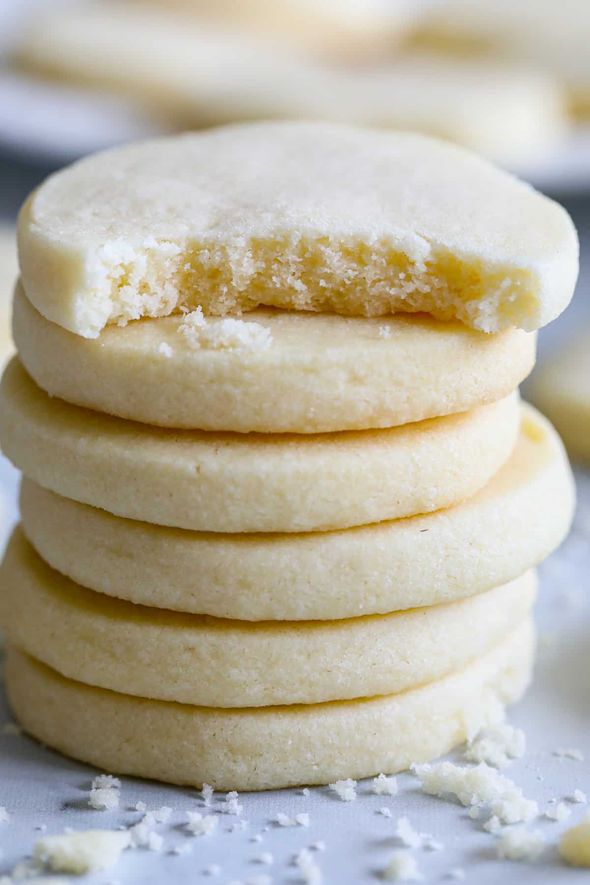 Stack of Classic Shortbread Cookies with a bite taken out of the top one.
