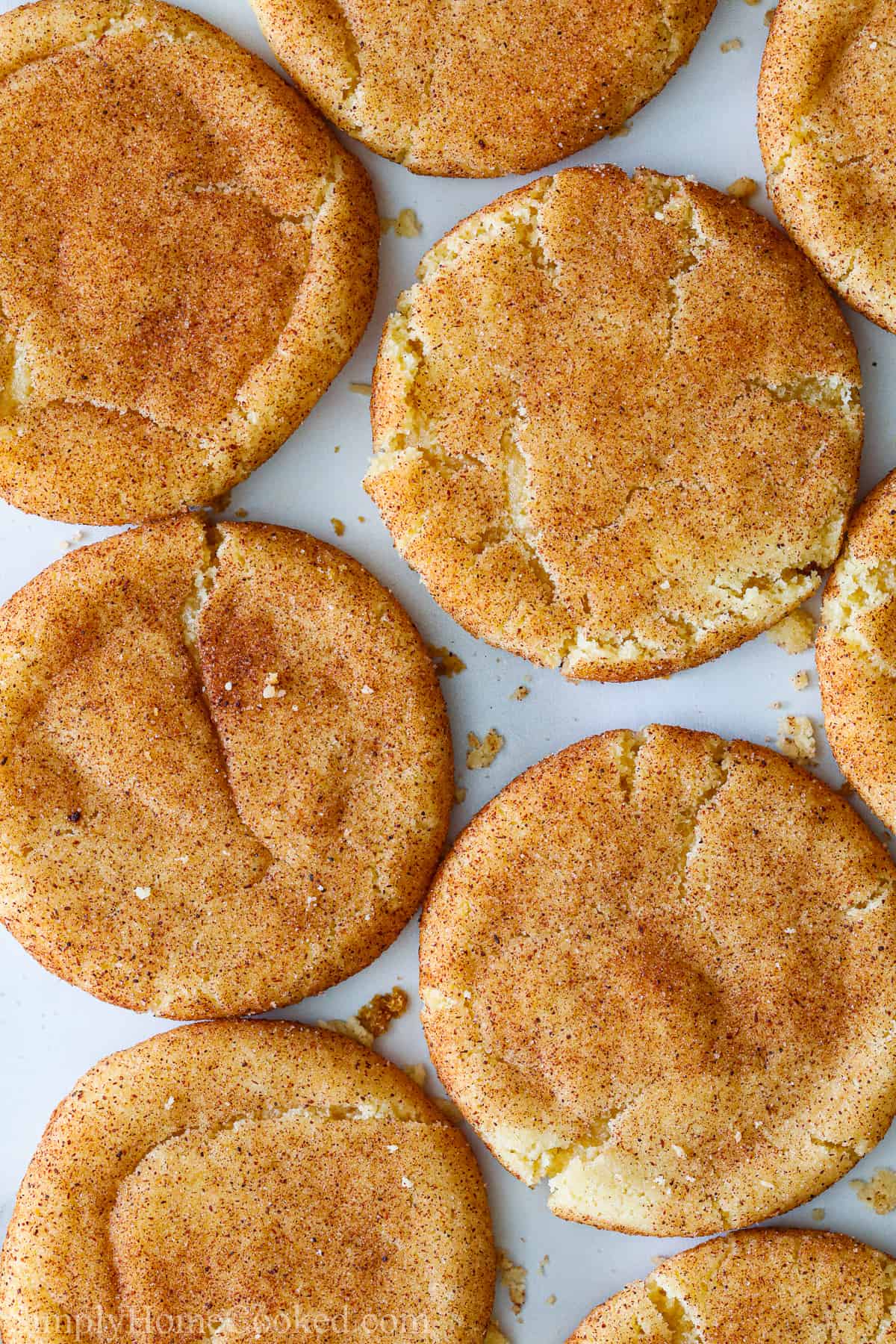 Soft Snickerdoodle Cookies spread out on a baking sheet.