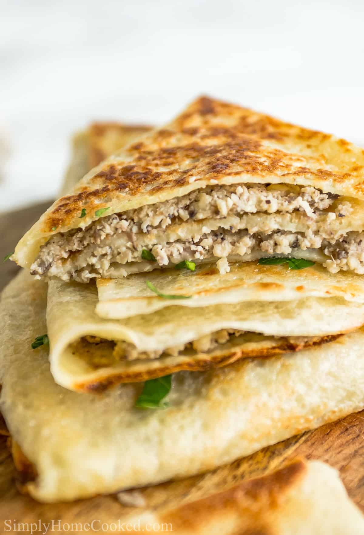 Closeup of a stack of Savory Crepes with Chicken and Mushroom Filling.