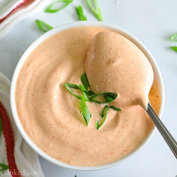 overhead photo of yum yum sauce in a white bowl with a spoon inside