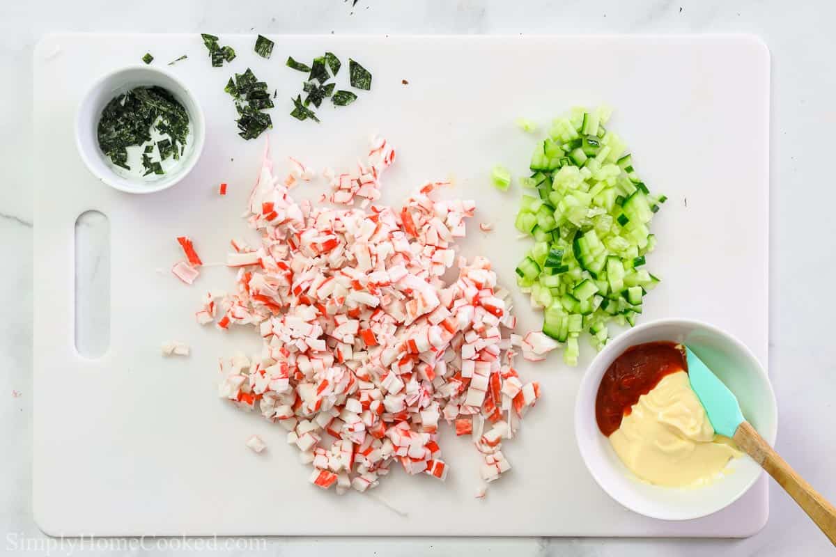 Steps to make California Sushi Bowls, including chopping the crab meat and cucumber, crumbling the nori sheets, and then making the spicy mayonnaise.