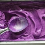 Easy Ube Ice Cream in a pan with a spoon.