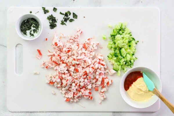 Steps to make California Roll Sushi Bowls: make the spicy mayo by combining the Japanese mayo and Sriracha, then chop the Nori sheets, cucumber, and imitation crab.