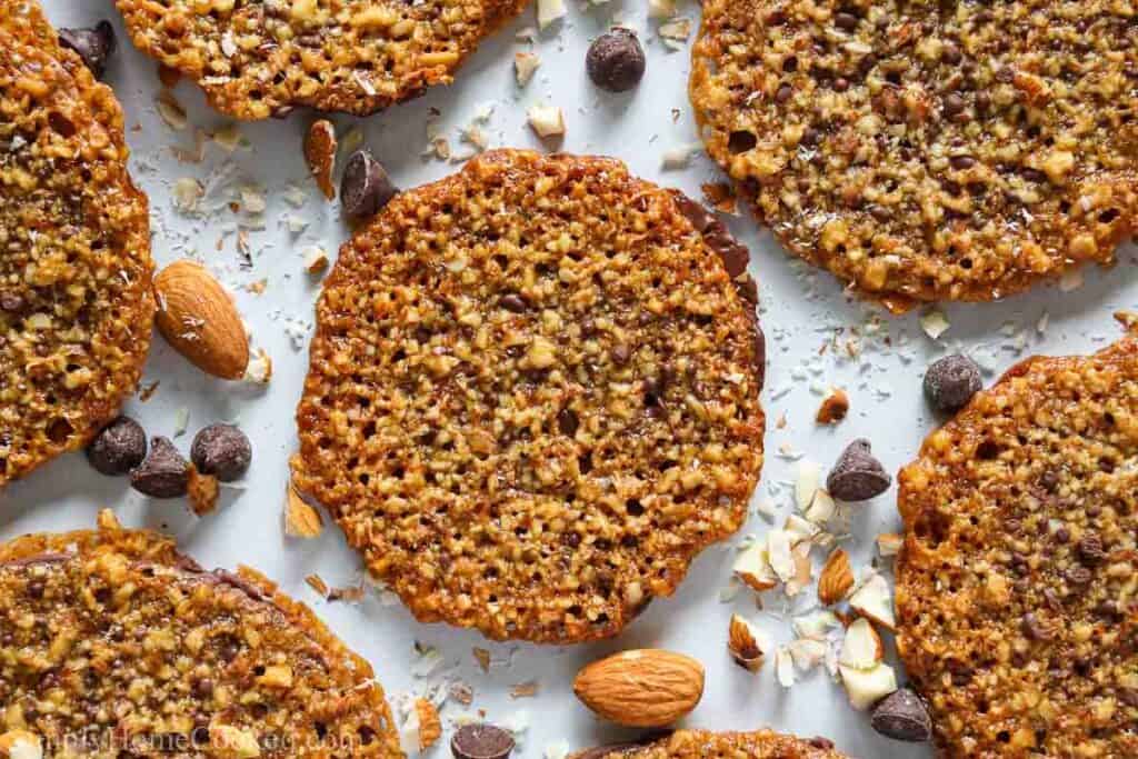 Do you need some delicious and gorgeous cookies to bring to a holiday party? These Chocolate Florentine Lace Cookies are chocolaty, pretty, and a snap to make. #easyflorentinecookies #easychocolateflorentinecookies #chocolateflorentinelacecookies #chocolateflorentinelaceholidaycookies image