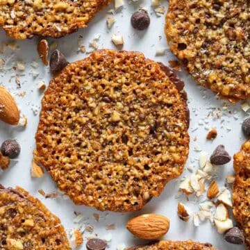 overhead image of chocolate florentine cookies with almonds and chocolate chips beside them