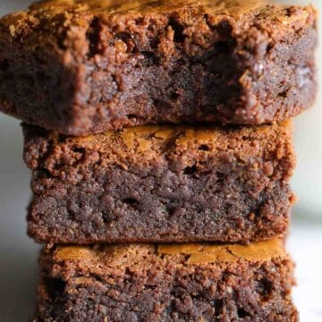 Nutella Brownies stacked on top of each other, one with a bite missing