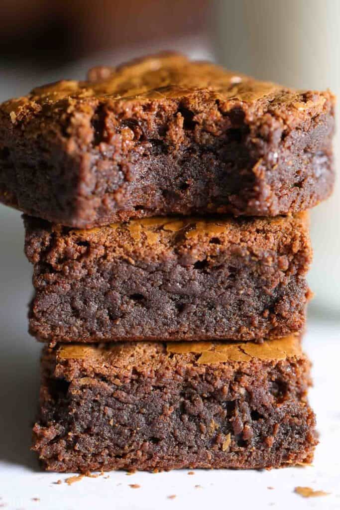 Nutella Brownies stacked on top of each other, one with a bite missing