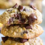 close up horizontal image of a stack of banana oatmeal chocolate chip cookies with melted chocolate oozing out