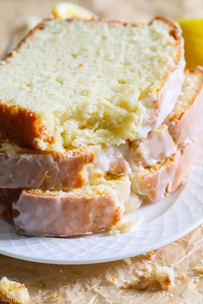 close up image of lemon pound cake slices stacked on top of each other.