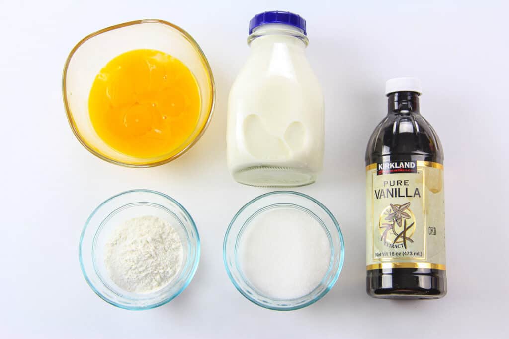 Ingredients for custard for Mini Fruit Tarts, including egg yolks, sugar, vanilla, milk, and flour.