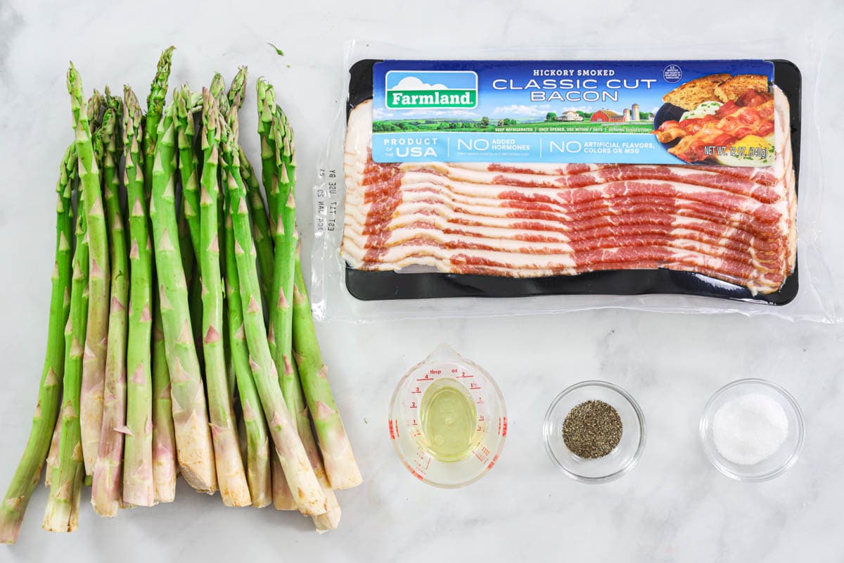 Ingredients for Bacon Wrapped Asparagus, including asparagus, bacon, oil, salt, and pepper