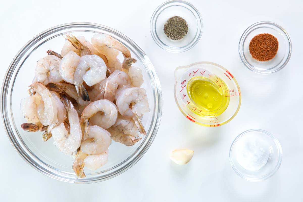 Ingredients for Air Fryer Shrimp, including shrimp, garlic,  olive oil, salt, pepper, and Cajun seasoning.